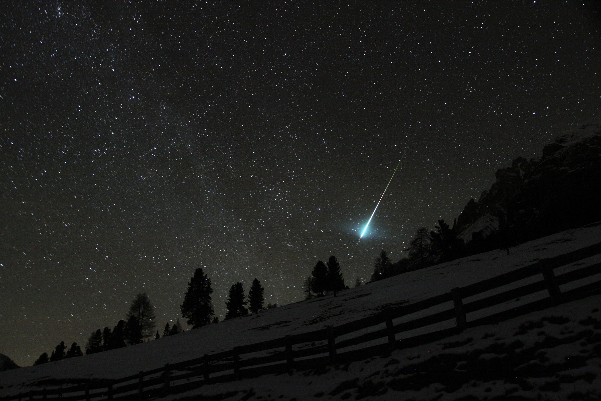 A meteor lights up the night sky....