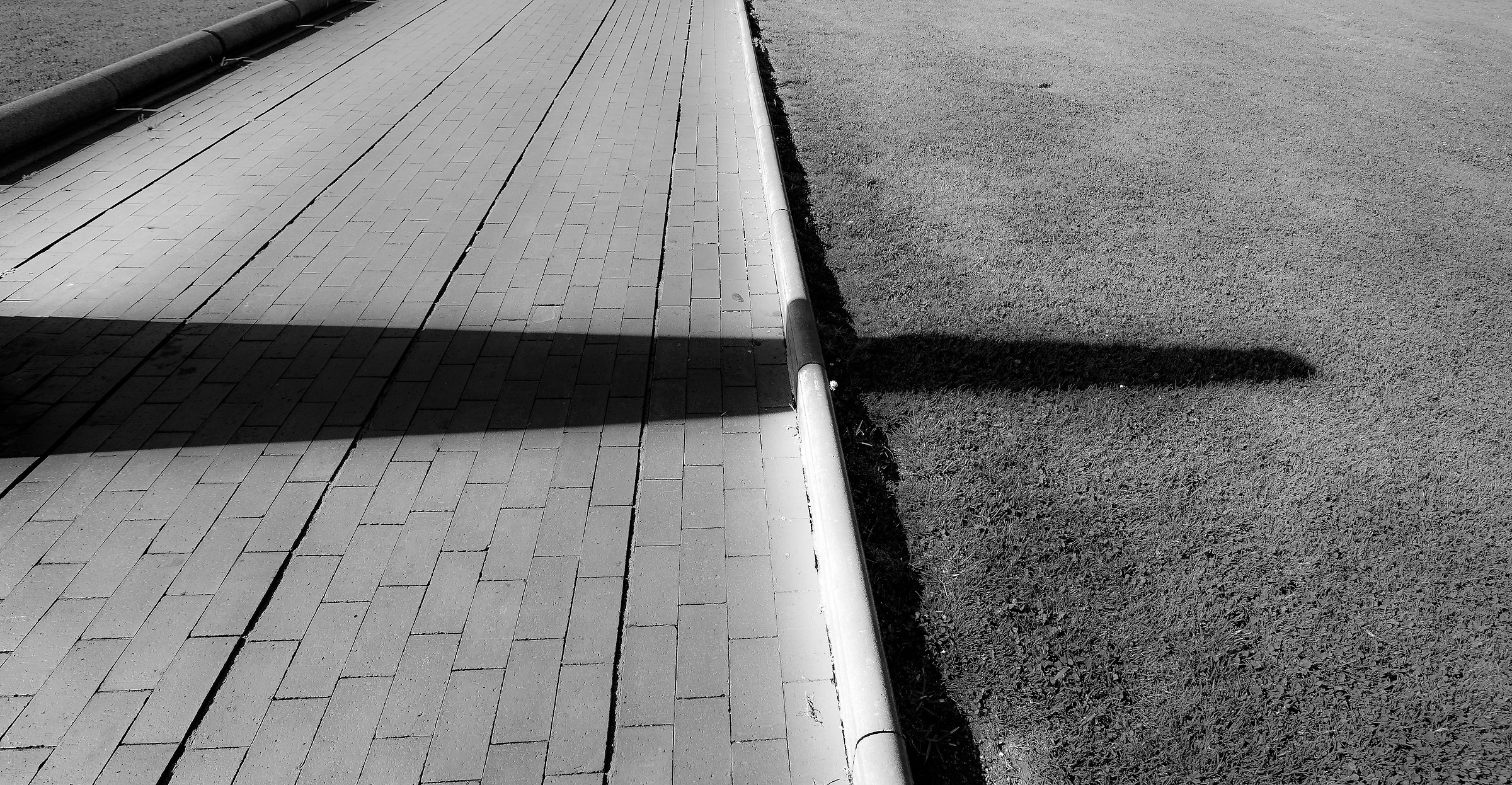 The relentless shadow walk past 'the curb ......
