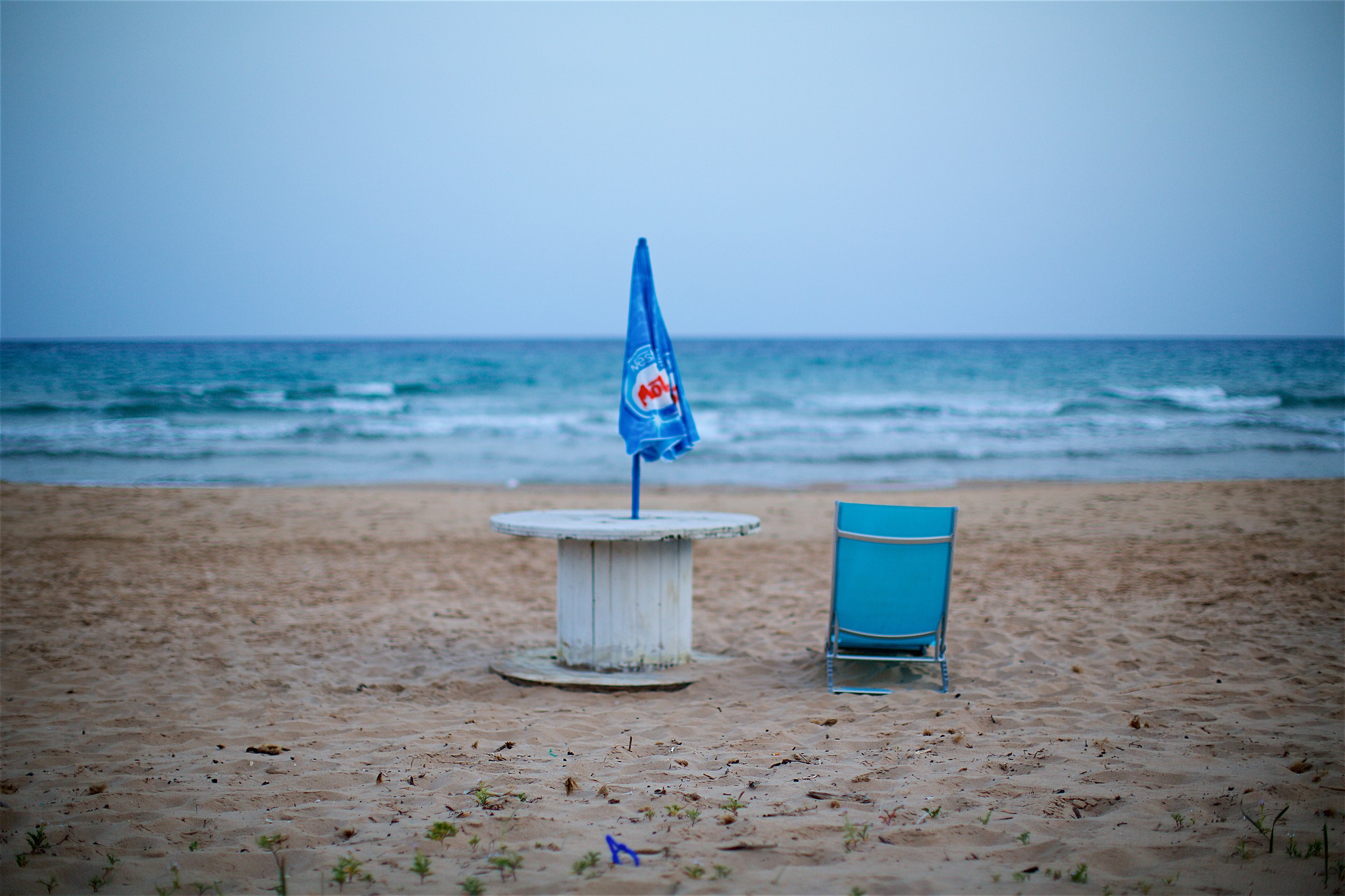 Beach: dialogue between a chair and an umbrella...