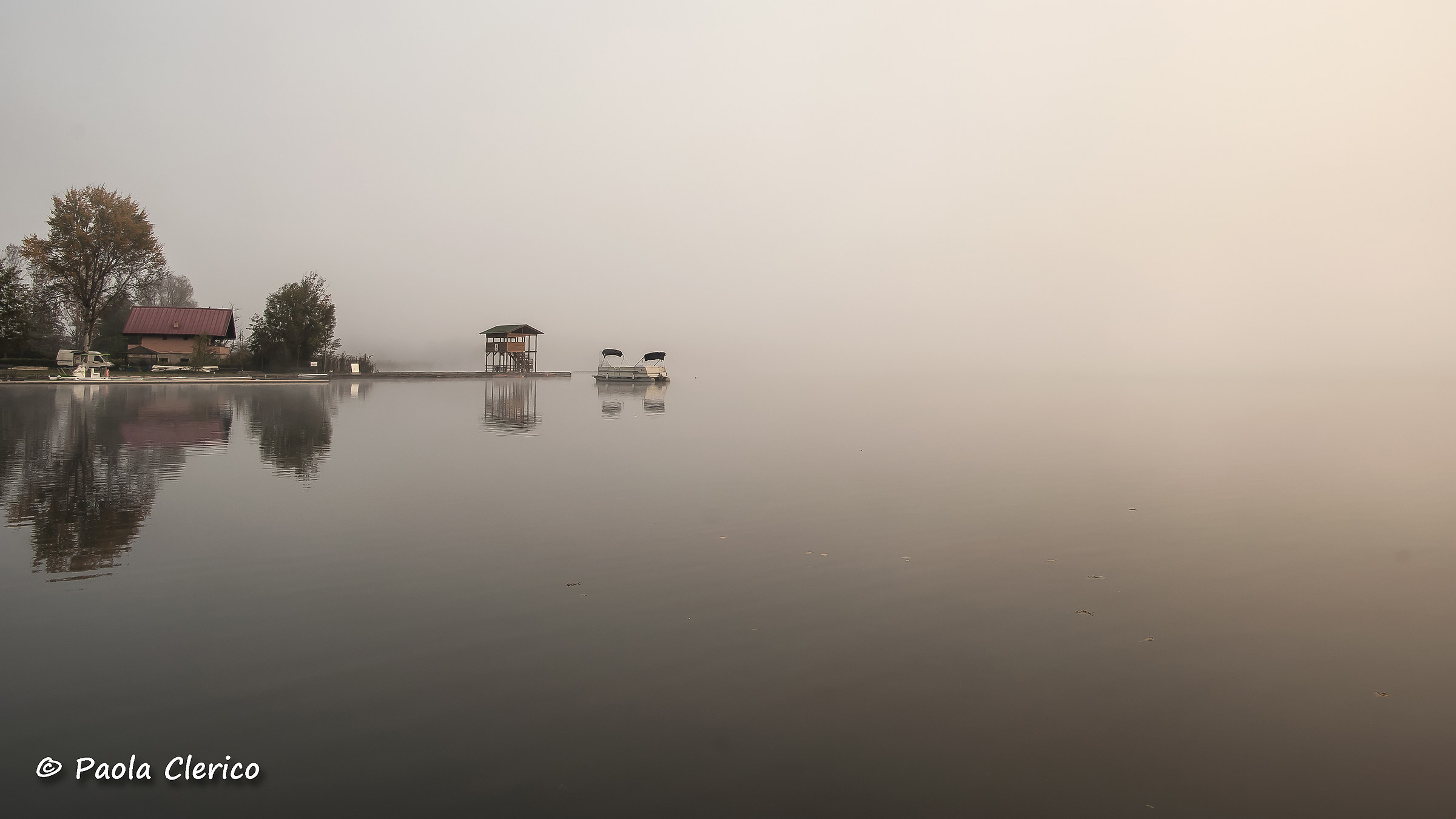 Sunrise in the fog on the lake...