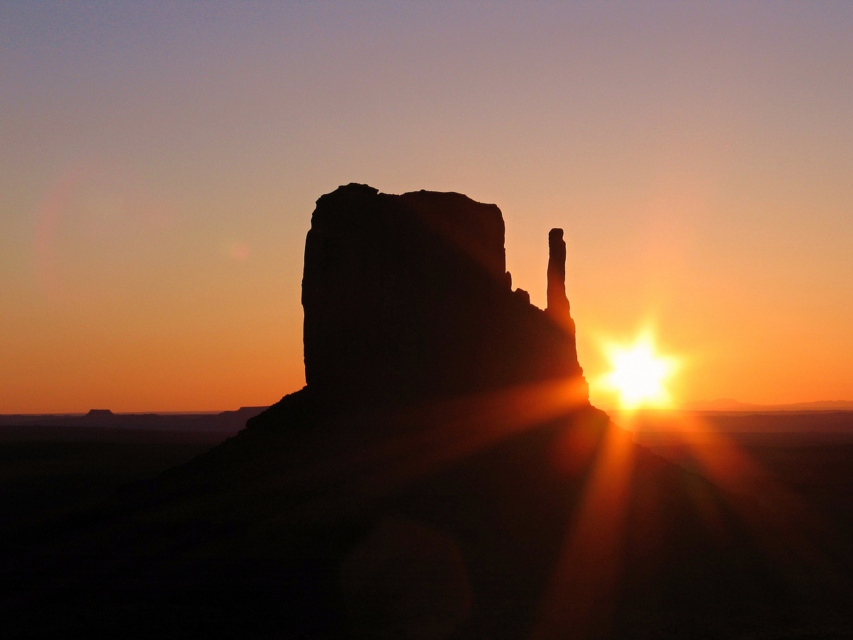 The sun rises behind the West Mitten...