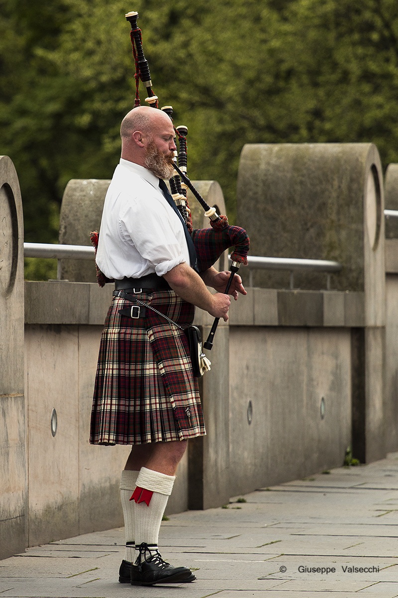 Man and Scottish bagpipe ........
