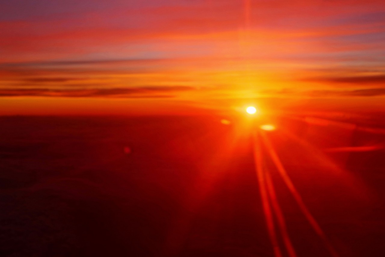 The sunrise from the plane settled...