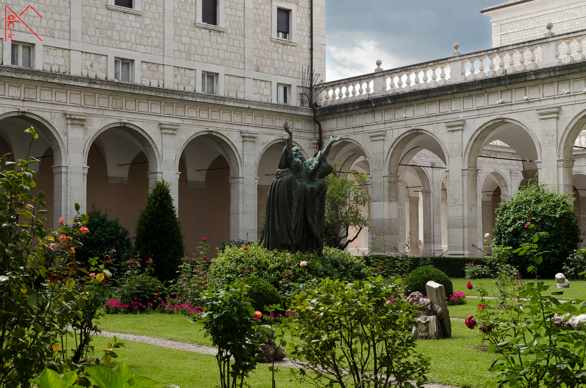 First cloister with a statue of St. Benedict...