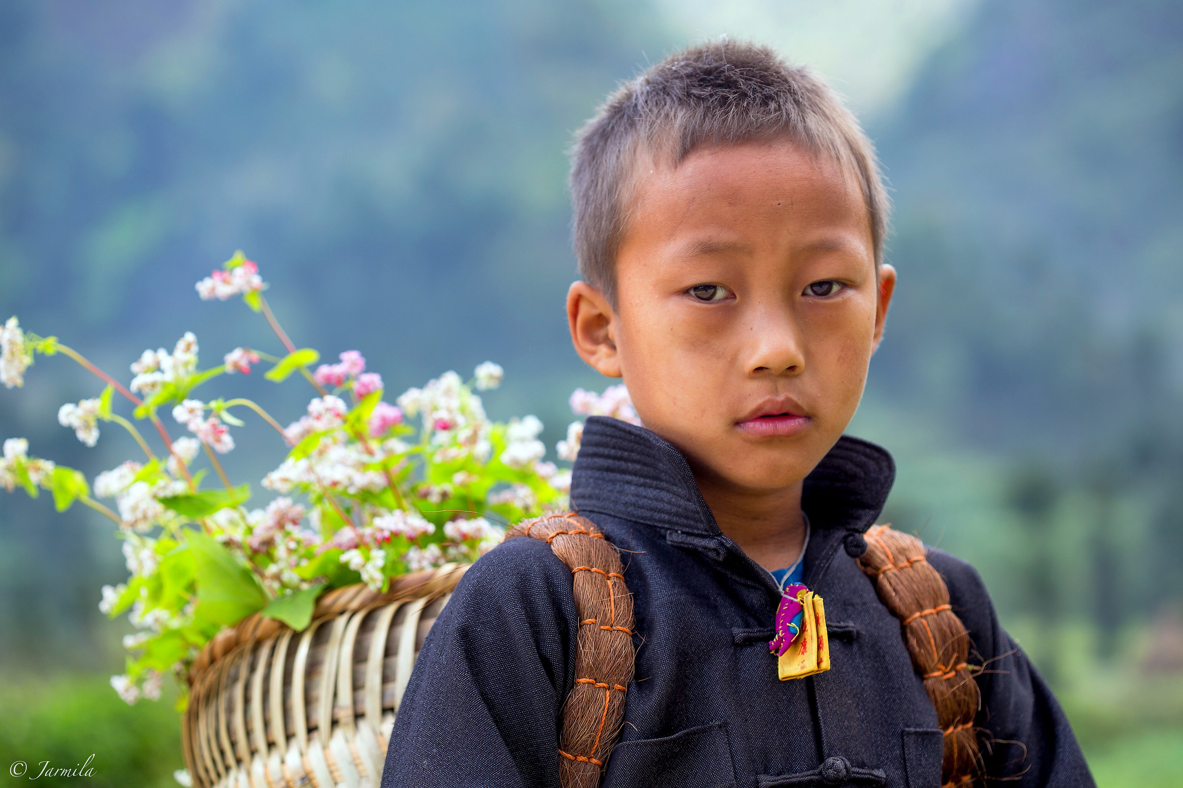 The Hmong boy with flower basket...