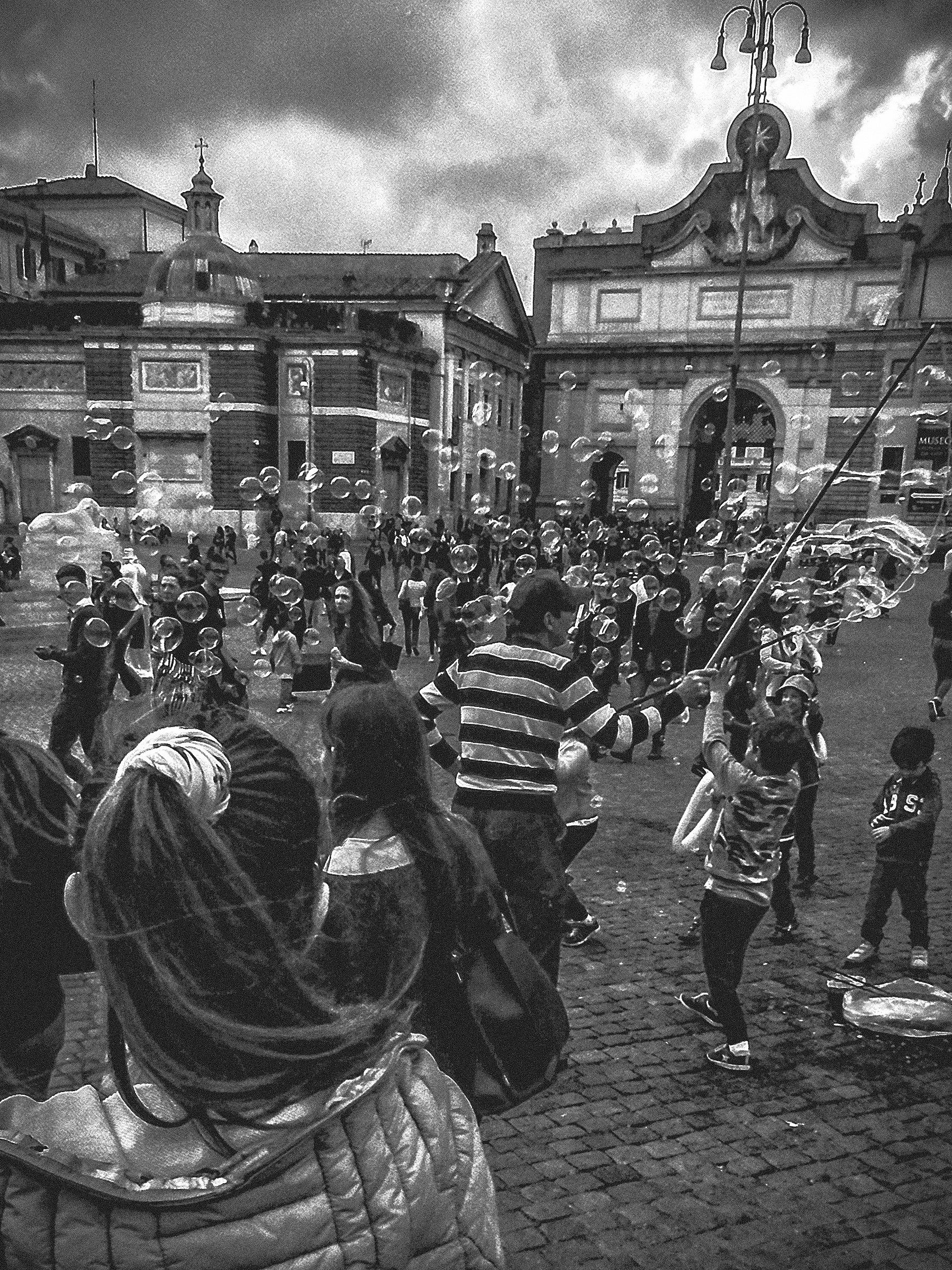 Children and bubbles in the square in Rome Bw...