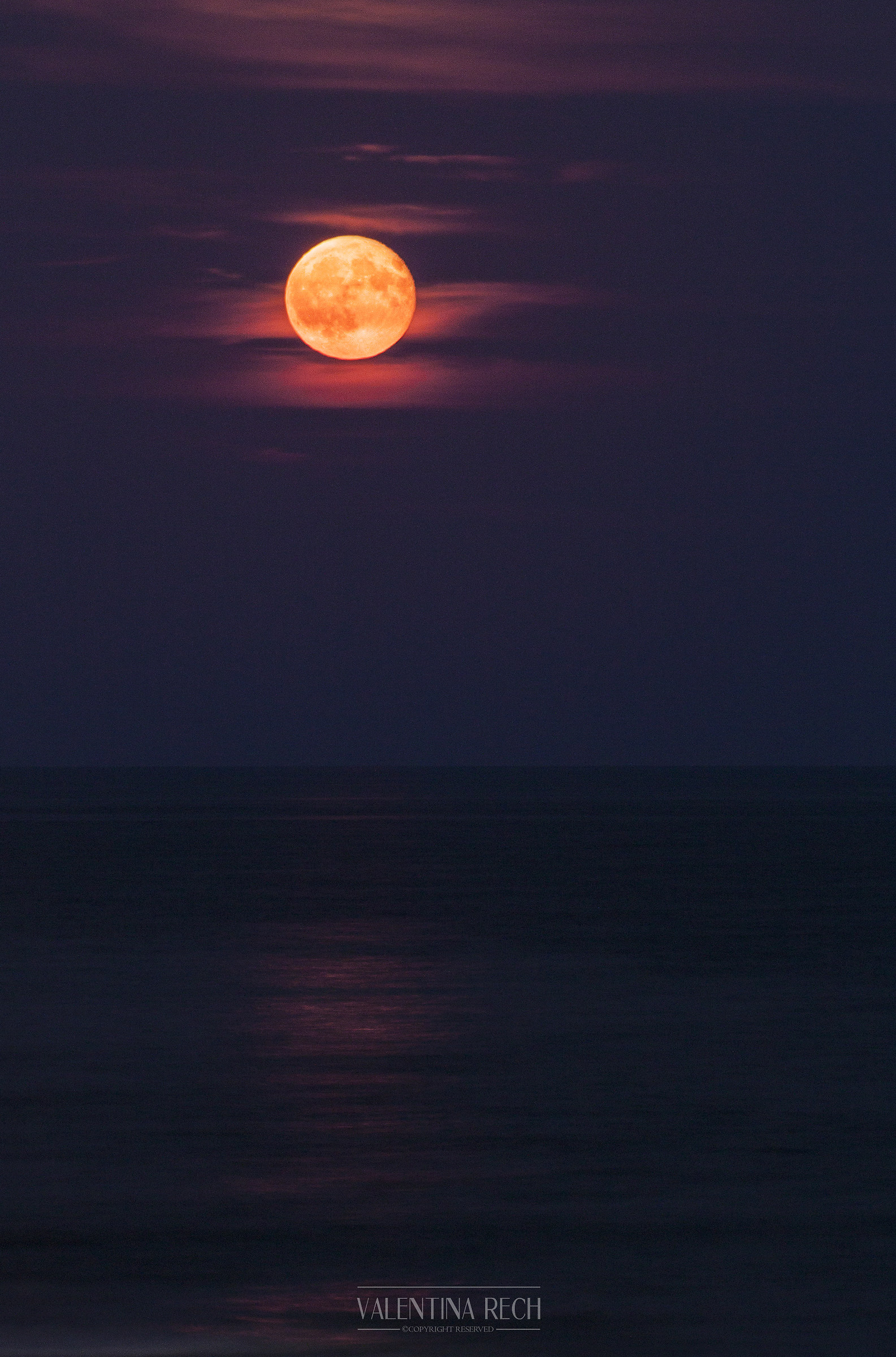 The moon rises over the sea...