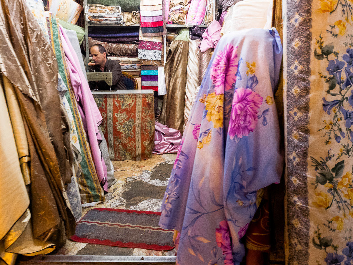 Bazaars of the Old City, a textile salesman...
