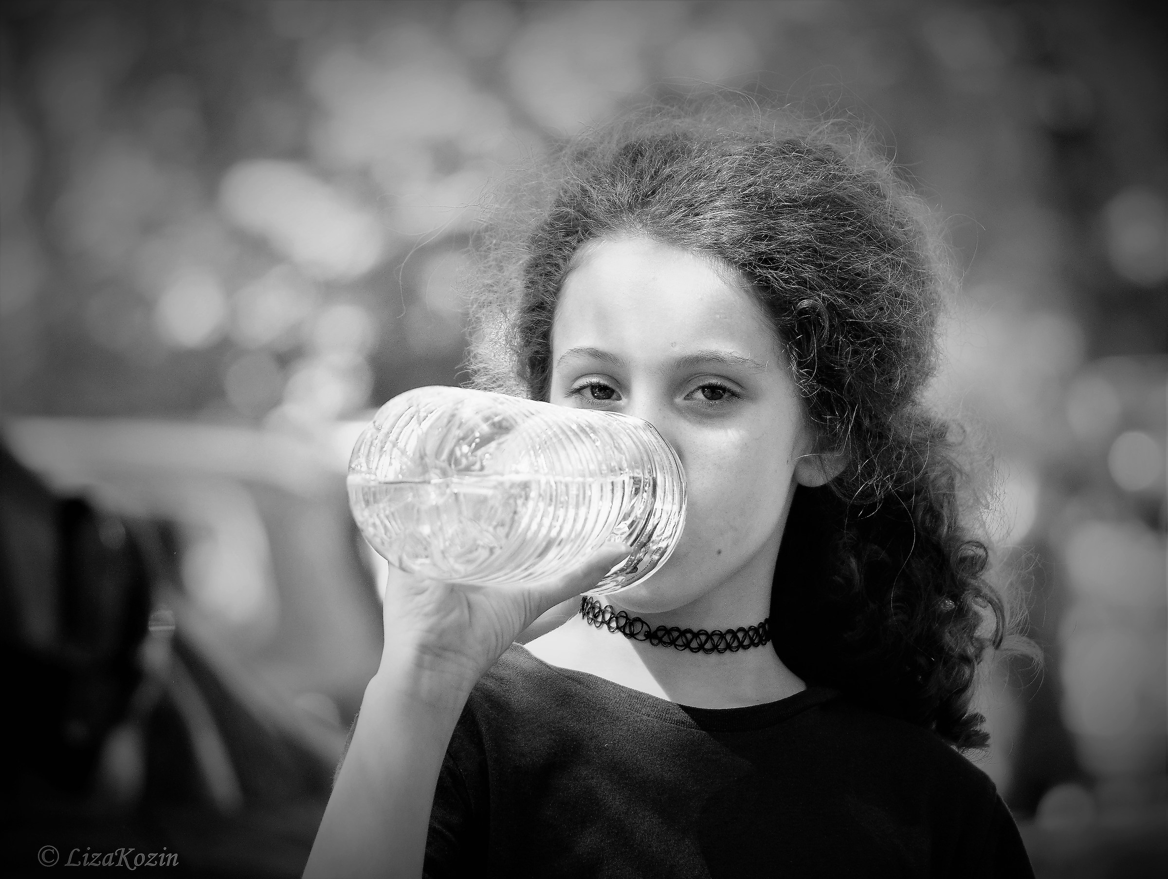 Little girl with bottle of water...