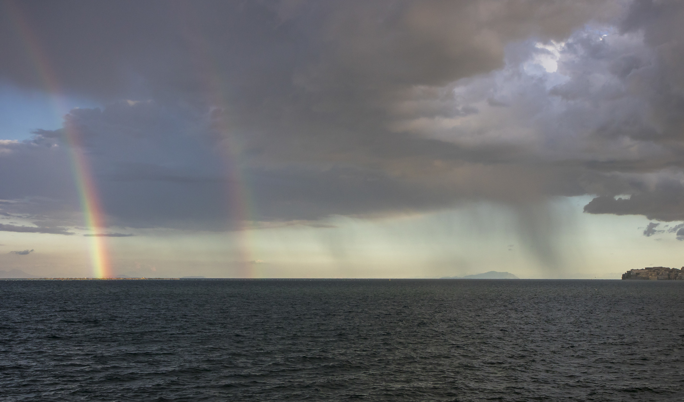 Two rainbows, the sea and the rain...