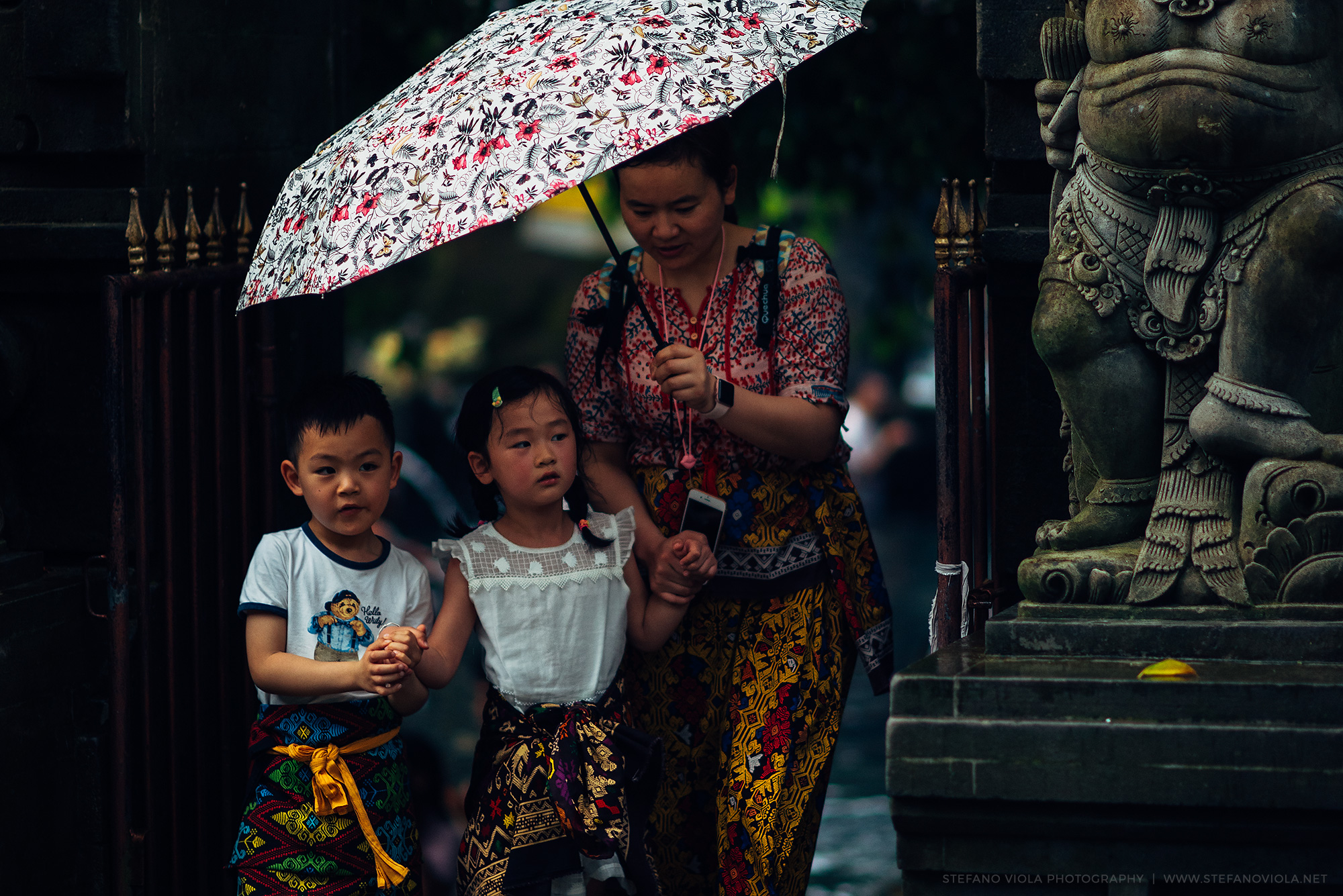 Mother and children at the sacred temple Tirta Empul...